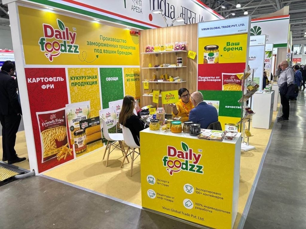 Daily Foodzz team in a sourcing discussion at the WorldFood Moscow 2026 stand with a Russian translator present