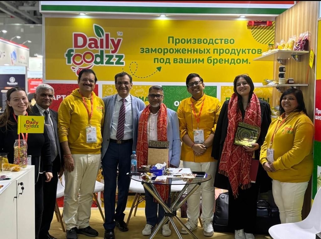 Daily Foodzz team in a sourcing discussion at the WorldFood Moscow 2026 stand with a Russian translator present